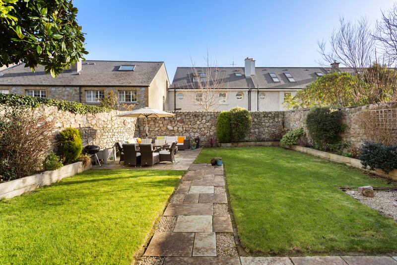 A door leads out to the gravelled back patio area with two handy storage shed. Photograph: Alex Urdaneta