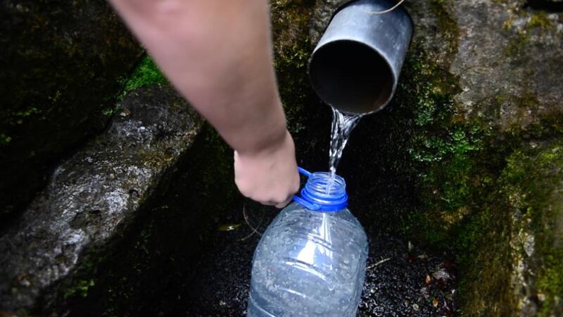 Filling water containers from a well outside Keadue, Co Roscommon. Photograph: Bryan O’Brien/The Irish Times