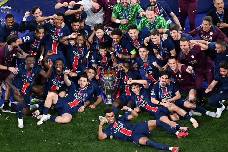 PSG celebrate with the Champions League trophy after beating Inter Milan in Munich. Photograph: Kirill Kudryavtsev/AFP via Getty Images