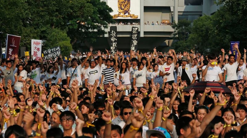 Students from various universities clench their fists during a demonstration at the Chinese University in Hong Kong today. Photograph: Bobby Yip/Reuters.