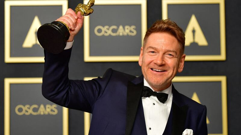 Kenneth Branagh poses with the award for best original screenplay for Belfast. Photograph:  Frederic J Brown/AFP via Getty Images