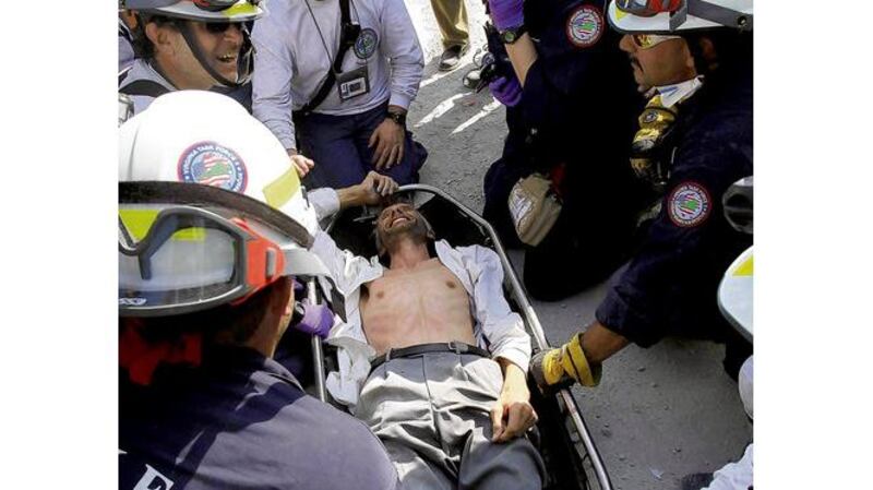 Search and rescue personnel tend to Jens Christensen, a Danish United Nations worker, shortly after being pulled from the rubble of the collapsed UN headquarters building. Photographs: Julie Jacobson, Gerald Herbert/AP Photo, Getty Images