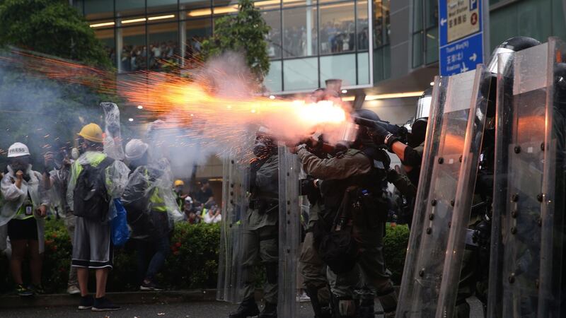 Riot police fire tear gas as protesters take part in an anti-government rally in  Hong Kong. Photograph: EPA