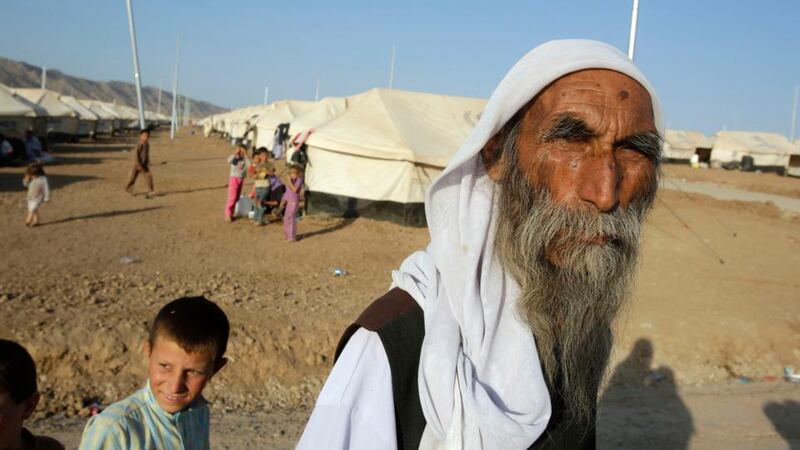 A man from the minority Yazidi sect fled violence in the Iraqi town of Sinjar. He  stands looks on in Bajed Kadal refugee camp. Photograph: Youssef Boudlal/Reuters