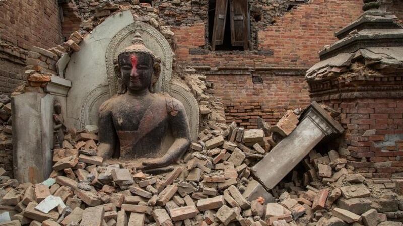 A Buddha statue is surrounded by debris from a collapsed temple in the Unesco world heritage site of Bhaktapur, Nepal, following the April 2015 earthquake. Photograph: Omar Havana/Getty Images