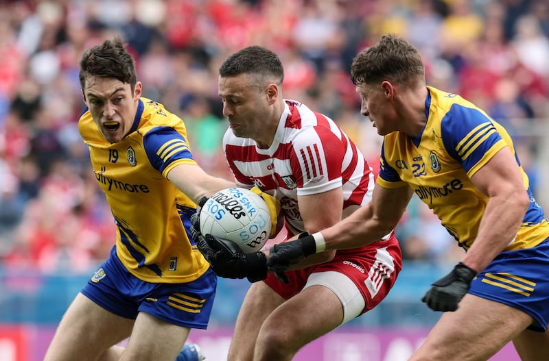 Cork's Míchéal Martin tackled by Richard Hughes and Conor Cox of Roscommon during preliminary quarter-final. Photograph: Lorraine O’Sullivan/INPHO