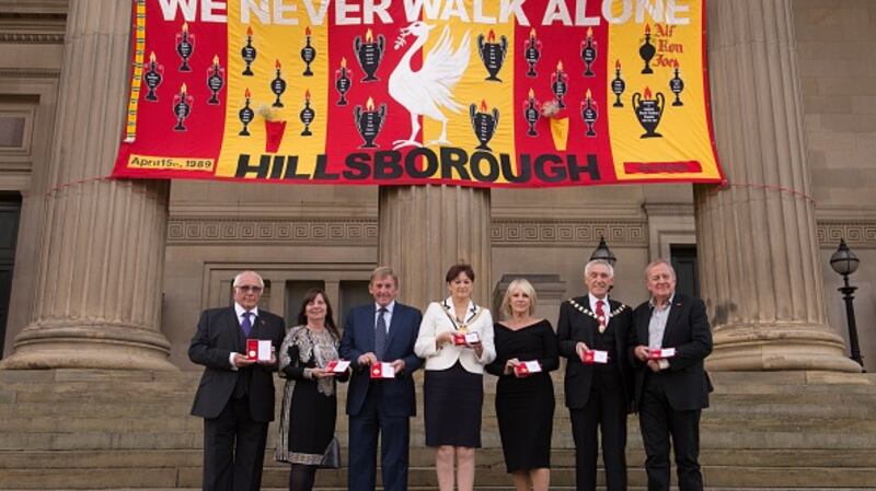 Trevor Hick, Margaret Aspinall, Kenny Dalglish, Roz Gladden, Marina Dalglish, Roy Gladden and Phil Scraton pose with Freedom of the City of Liverpool medals outside St George’s Hall. Photograph: Getty Images