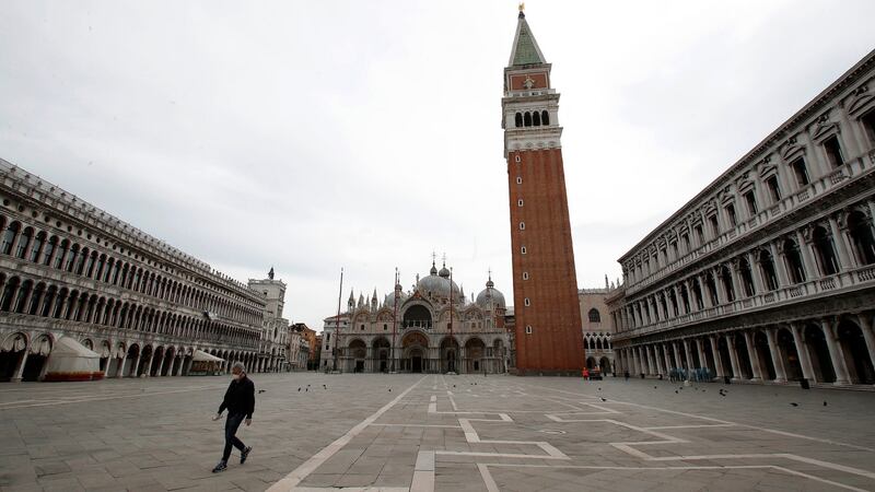 A man walks through St Mark’s Square in Venice, Italy. Photograph: Antonio Calanni/AP