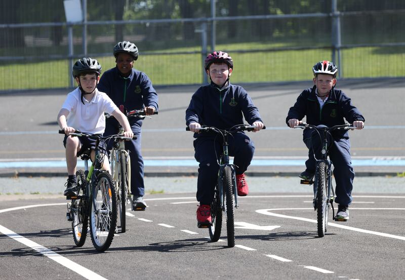 Scoil Iosagáin pupils (from left) Joe Eustace (10), Jubril Musa (11), Carter Cusack (11) and Tomás Doherty (10),  in Eamonn Ceannt Park, Crumlin, for the opening of Dublin City Council’s new mobility school. Photograph: Bryan O’Brien/The Irish Times 

