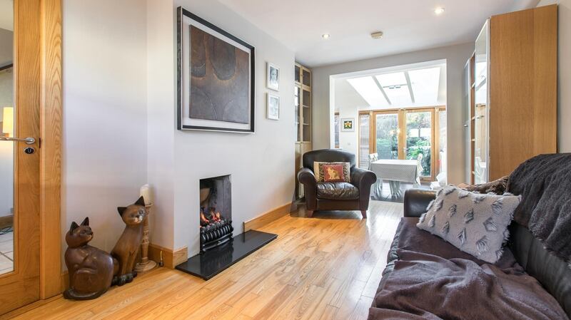 The long livingroom has  a solid oak floor and a small coal-effect gas fire