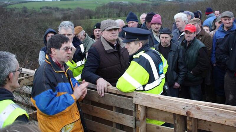 Border protest: Liam O’Mahony (left), chairman of the Great Southern Trail, and Cllr Denis Stack of Listowel, on either side of the barricade that Kerry farmers erected on the county boundary in protest against plans to extend the trail. Photograph: Jim McNamara
