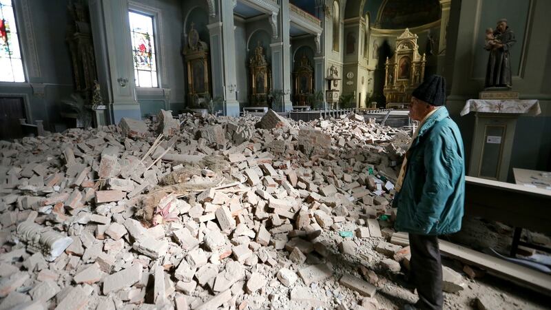 A man looks at damages at the Basilica of the Heart of Jesus, following an earthquake in Zagreb on Sunday. Photograph: Antonio Bronic/Reuters