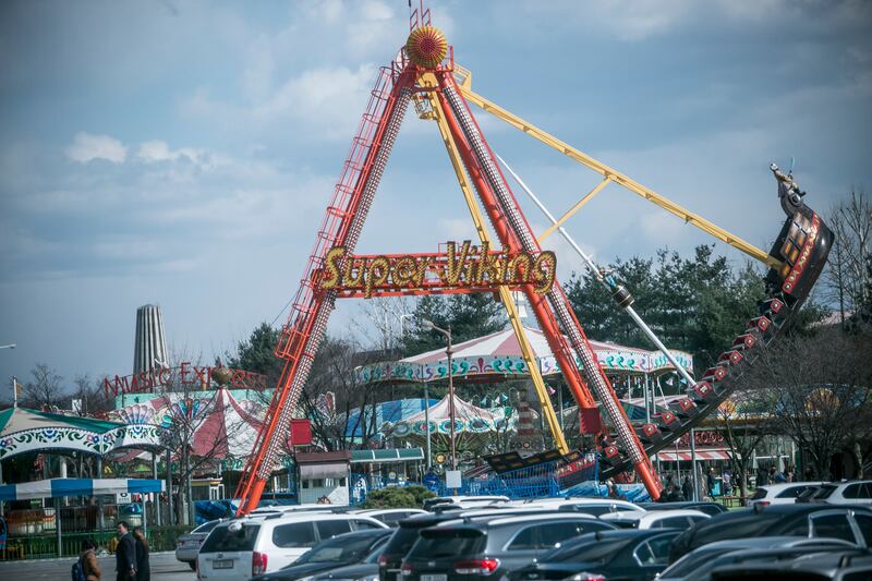 Visitors go on a ride amusement park near the fortified Demilitarised Zone (DMZ) in Paju, South Korea. Photograph: Jean Chung/Getty 