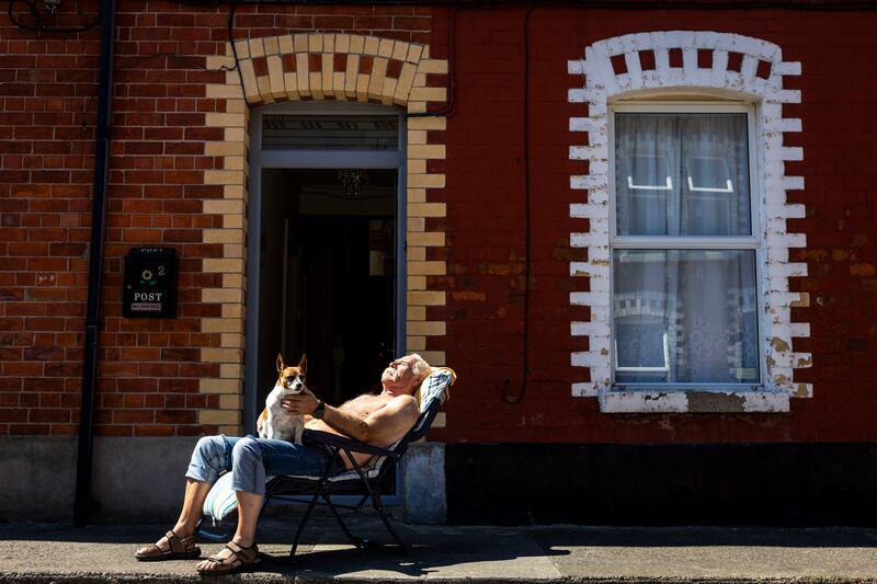 Paddy Moylan and Minni the terrierenjoying the sunshine on Somerset Street, Ringsend, Dublin, last week. Photograph: Tom Honan