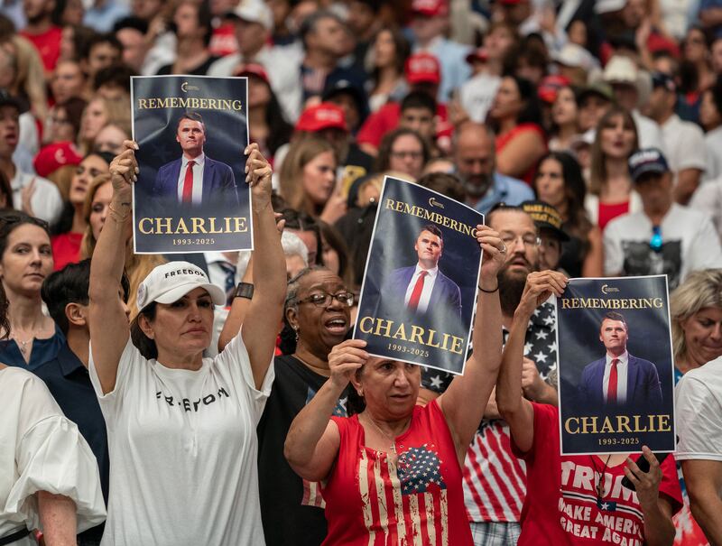 Attendees hold up images of Charlie Kirk during a memorial service for him at State Farm Stadium in Glendale, Arizona, on Sunday. Photograph: The New York Times 