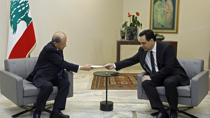 Lebanese prime minister Hassan Diab (R) submitting his resignation to president Michel Aoun at the presidential palace in Baabda, east of the capital Beirut. Photograph: Dalati and Nohra/AFP/Getty