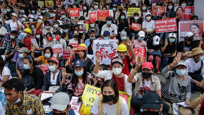 Demonstrators holding placards flash the three-finger salute during a protest against the military coup in Yangon on Saturday. Photograph: Lynn Bo Bo/EPA