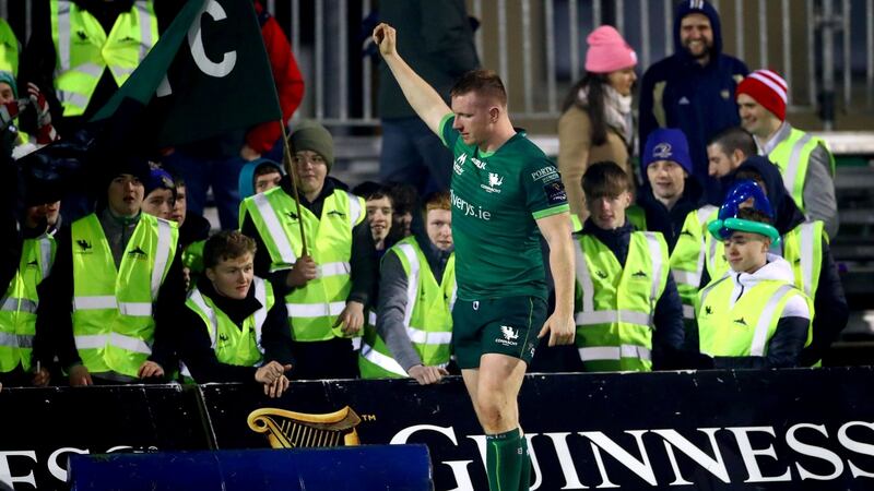 Fans wearing high vis vests watch Connacht take on Munster. Photograph: James Crombie/Inpho