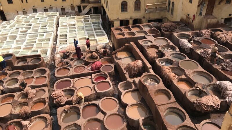 The vats are richly hued receptacles, ready to give colour to the leather. There is poppy red, henna orange, indigo blue.