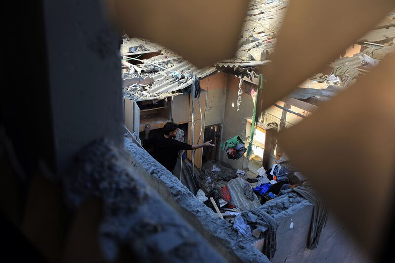 Palestinians searching for salvageable items in the wreckage of a house after an Israeli air strike on Khan Younis. Photograph: Yousef Masoud/The New York Times
                      
