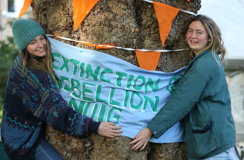 WELL ROOTED: Ruth Kiely and Hannah McSweeney, who study environmental science at Trinity College Dublin, at an Extinction Rebellion action at Merrion Square, Dublin, as part of a week of efforts to disrupt 60 cities around the world demanding drastic governmental action on climate change. Photograph: Stephen Collins/Collins Photos