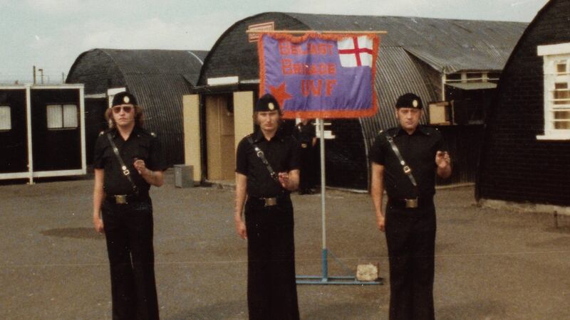 ‘Trevor King, me and Billy Mitchell, with the UVF colours and the huts behind us.’ Photograph: Eddie Kinner/From My Life in Loyalism