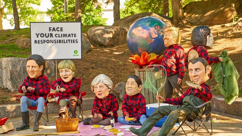 Oxfam activists imitate the leaders of the G7 nations as they protest against the warming global responsibility during the G7 Summit in Quebec City. Photograph: Andre Pichette/EPA
