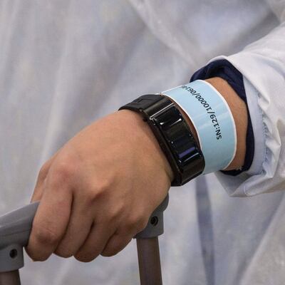 Track and trace: a newly arrived passenger wears a quarantine-tracking wrist band in Hong Kong last year. Photograph: Anthony Wallace/AFP via Getty