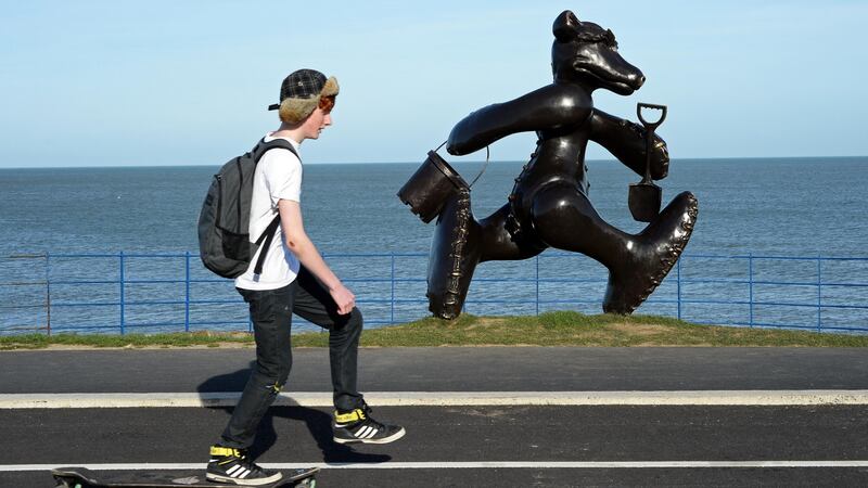 A skateboarder passing a  bronze teddy bear sculpture by Patrick O’Reilly at the seafront in  Greystones. Photograph: Eric Luke