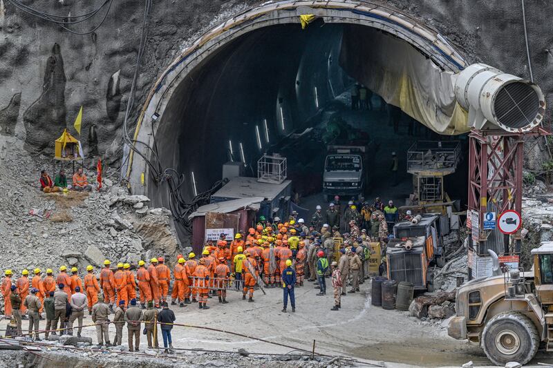 Rescures gather near the face of the collapsed Silkyara tunnel. Photograph: Sajjad Hussain/AFP via Getty Images