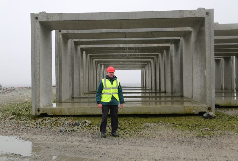 Mark White, Marine Development Expert and  Marine Renewable Energy Consultant pictured beside some of the caissons that will form the new pier at Rossaveel, Co. Galway.Photo: Bryan O’Brien / The Irish Times

