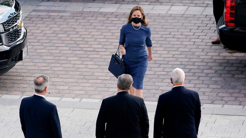 US judge Amy Coney Barret arrives to be escorted to the Senate by vice-president Mike Pence for meetings on September 29th in advance of her confirmation hearing. Photograph: Susan Walsh/AFP via Getty Images