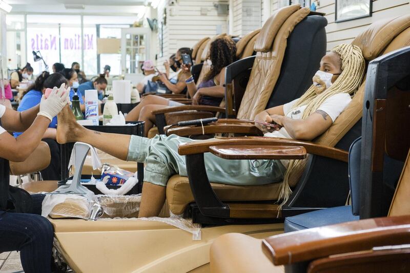 Stephanie Stevens gets her nails done at Million Nails as New York City. With mounting scientific evidence that the coronavirus can remain airborne for hours, experts recommend that people minimise their time indoors with non-family members. Photograph: Gabriela Bhaskar/The New York Times