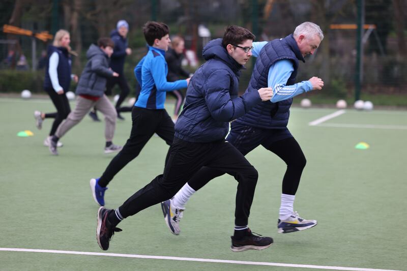 Adam Barry running with his coach Colm Gilmore. Photograph: Dara Mac Dónaill