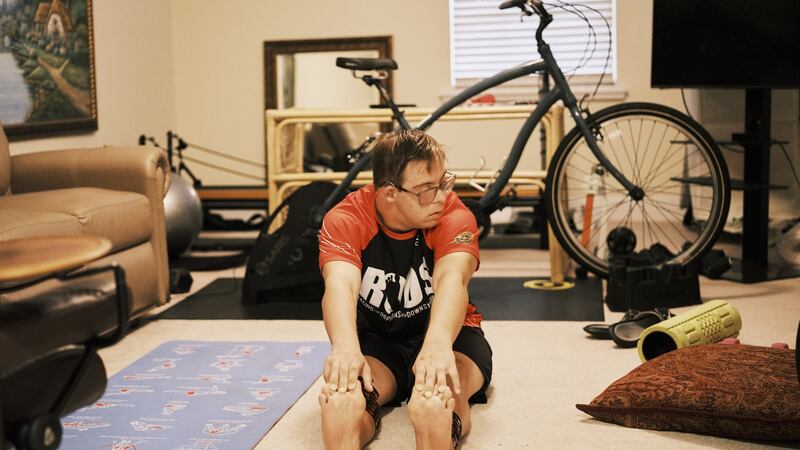 Chris Nikic stretches at his home in Maitland, Floridea. Photograph: Zack Wittman