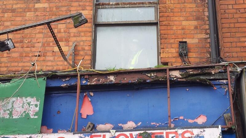 A member of the Save Moore Street campaign stands at the upstairs window of Number 15 Moore Street. Photograph: Éanna Ó Caollaí/The Irish Times