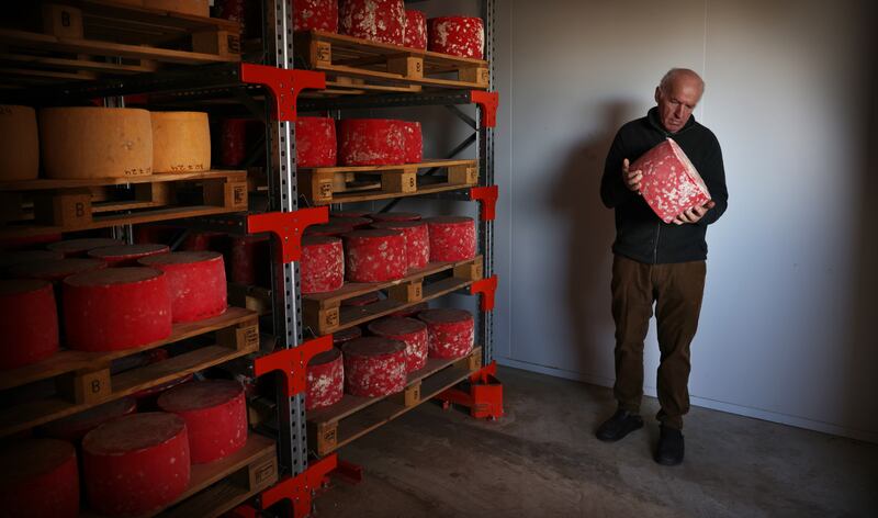 Tom Burgess of Coolattin Cheddar examines his cheeses