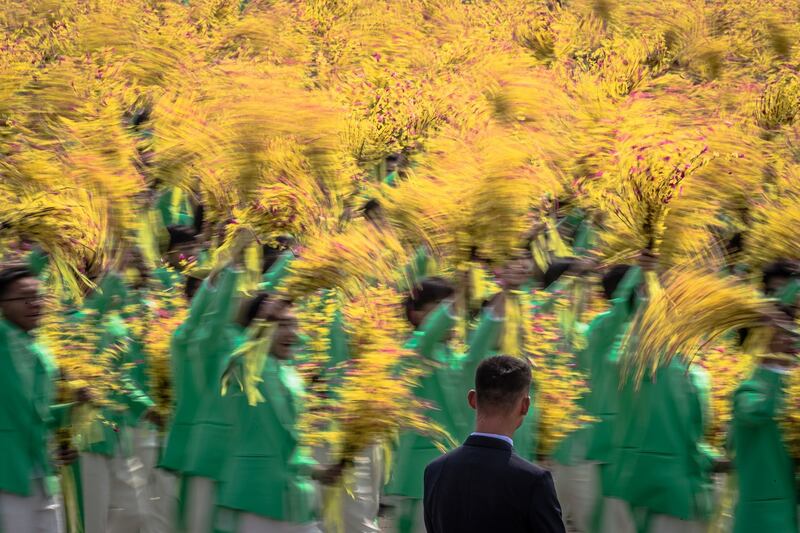 Participants marching past Tiananmen Square. Photograph: EPA/Roman Pilipey