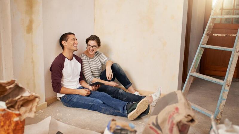 Shot of a young couple using a digital tablet while renovating their home together