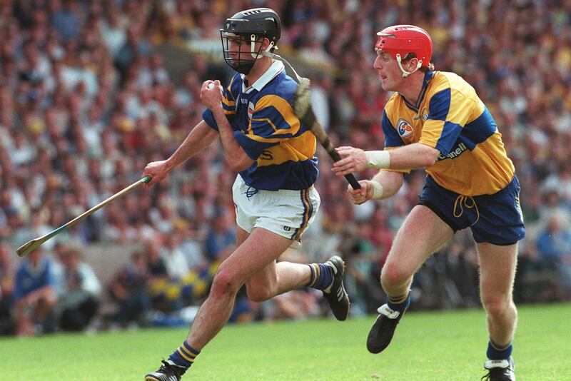Tommy Dunne evades the challenge of Clare's Brian Lohan during the 1997 Munster Senior Hurling Championship final. Photograph: Lorraine O'Sullivan/Inpho