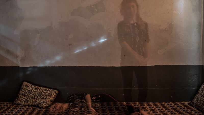 Amina Ismail Elias, (20), poses in her house on Mount Sinjar. “I am very very depressed. Medication makes me sleepy to I stopped taking the pills.” Photograph: Emilienne Malfatto