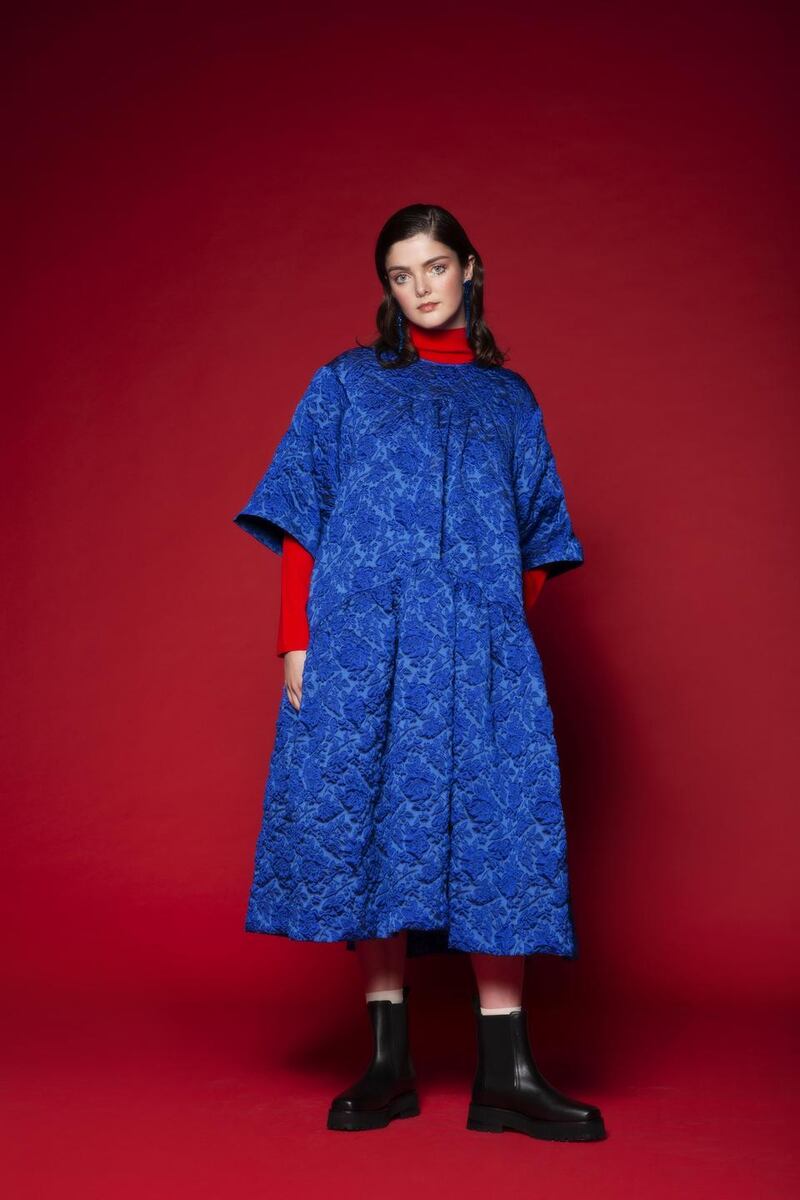 Blue drop earrings, €235, blue brocade dress, €1400, both Simone Rocha, Havana; red polo jumper (worn underneath), €69, chunky boots, €150, both & Other Stories