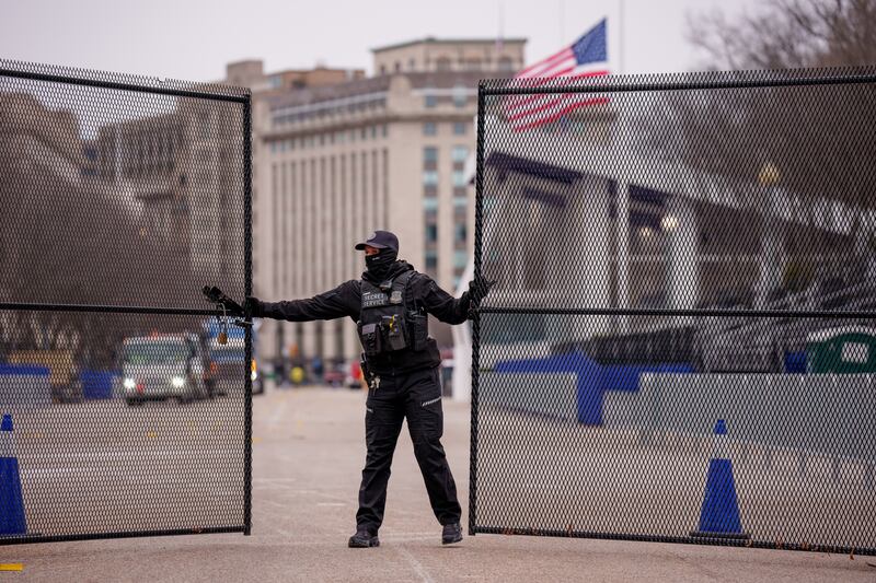 A member of the US Secret Service closes a security gate near the presidential inauguration parade review stand on Pennsylvania Avenue, Washington DC, on Thursday. Photograph: Andrew Harnik/Getty