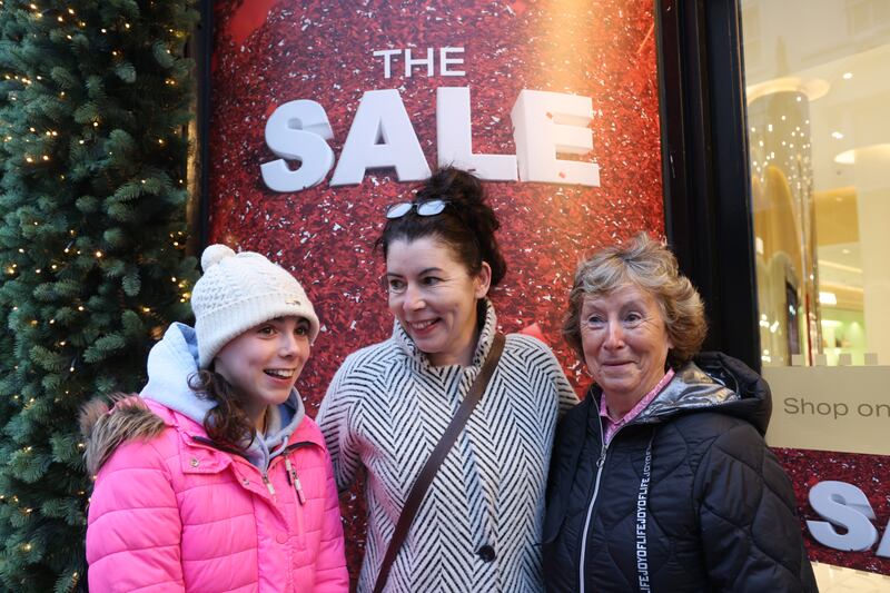 Nuala O'Grady (right) from Brittas Bay with her daughter Heidi and granddaughter Maya among customers waiting outside Brown Thomas on Thursday morning. Photograph: Bryan O’Brien/The Irish Times
