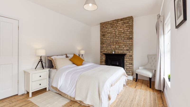 The master bedroom features a cast-iron fireplace.
