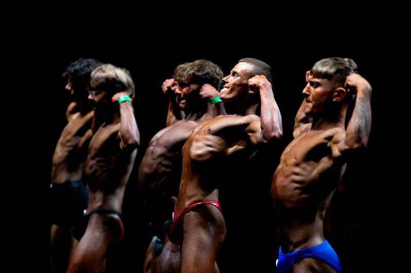 Competitors in the Teenage Men Bodybuilding category performing the double-bicep pose for judges. Photograph: Tom Honan 