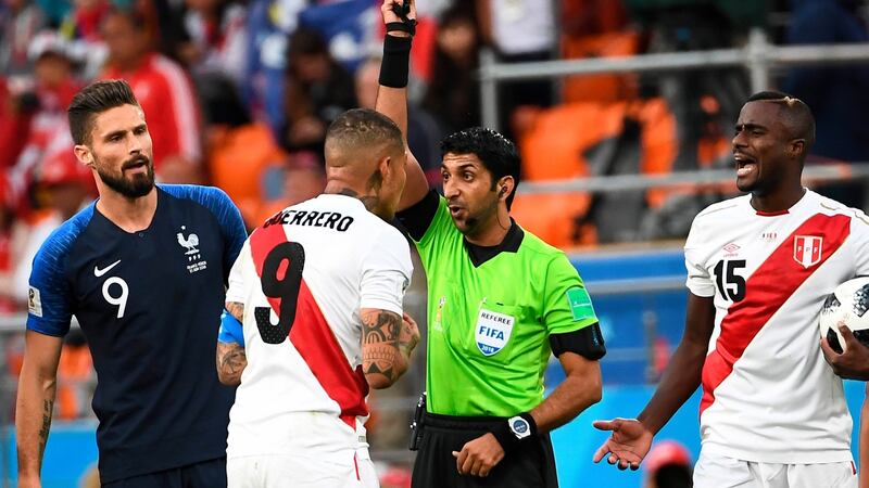 Referee Mohammed Abdulla Mohamed shows Peru’s Paolo Guerrero a yellow card during his side’s defeat to France. Photograph: Anne-Christine Poujoulat/AFP