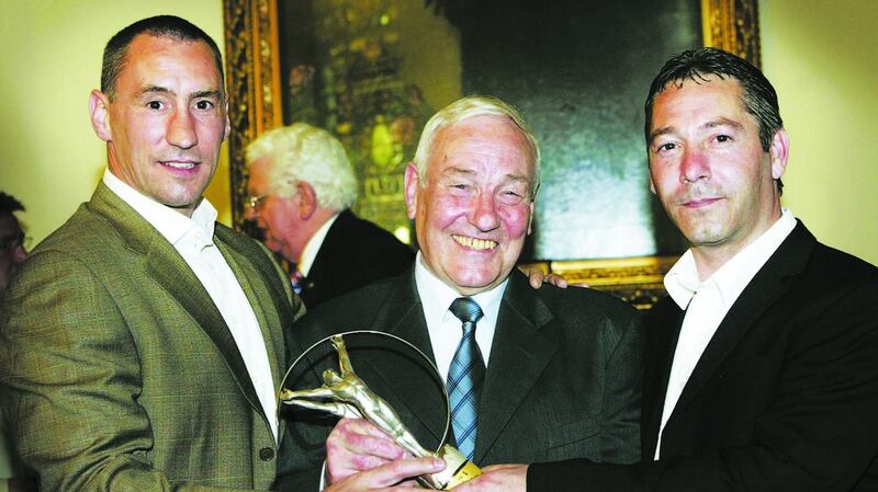 Gerry Storey with his sons Sam and Martin at an event in his honour in Belfast City Hall in 2005. Photograph: Hugh Russell