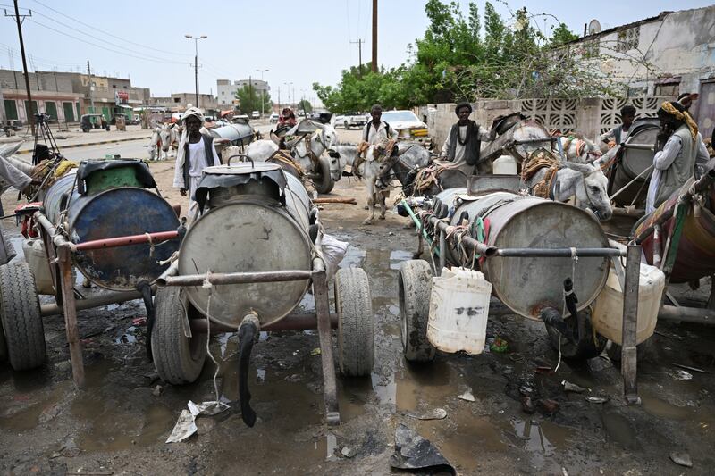 Sudanese people queue for water in Port Sudan on Monday, after the Arbaat dam collapsed as a result of heavy rain.  Photograph: Ibrahim Ishaq/AFP
