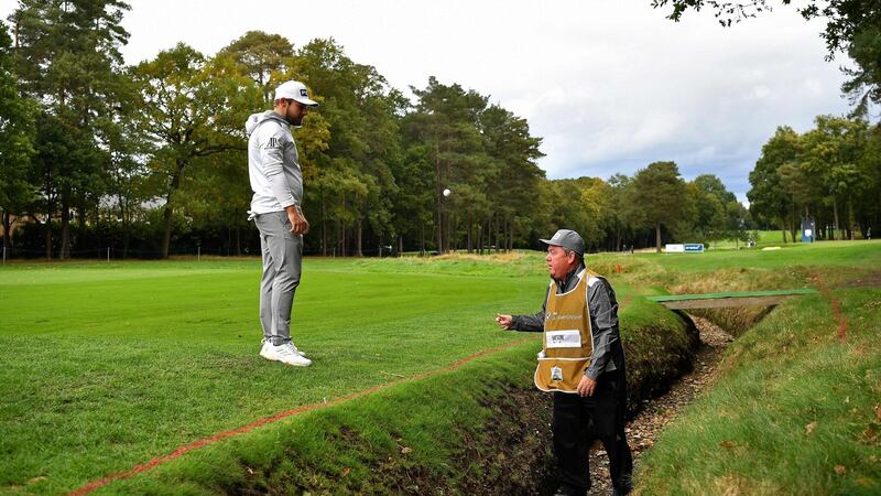 Hatton retrieves his ball after finding the ditch at the 15th. Photo: Ben Stansall/AFP via Getty Images
